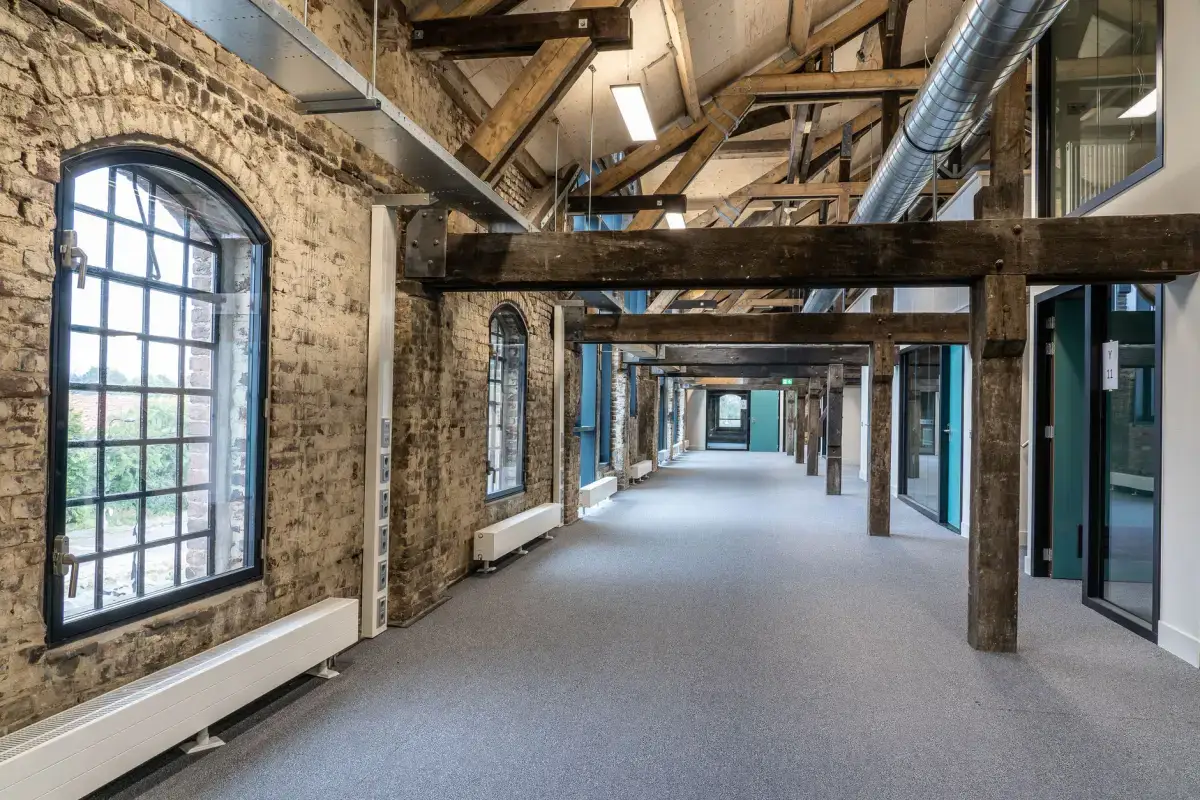 Commercial corridor with drywall walls of the kind that take repeated cart and trolley damage